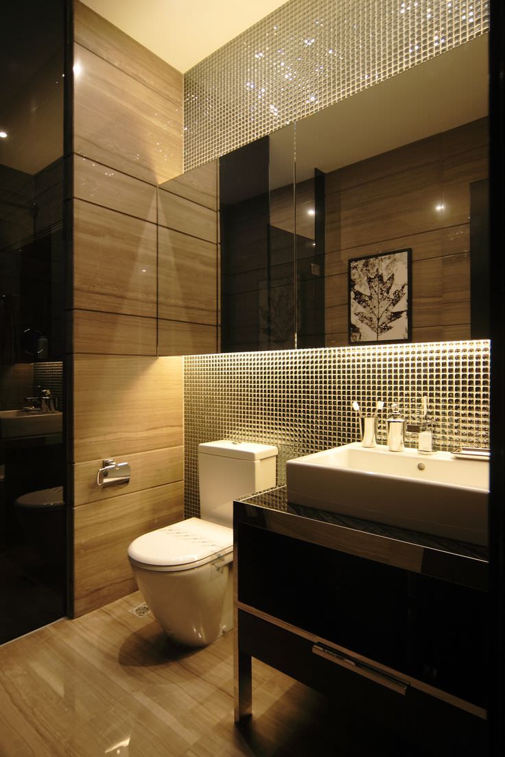 a bathroom with a toilet, sink and mirror