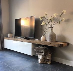 a tv is on top of a wooden shelf