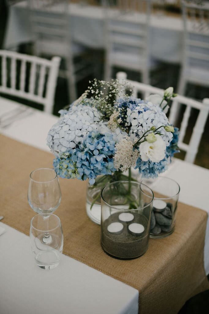 Blue Color Wedding Theme For A Stunning Rustic Beach In New Rustic Beach Wedding Burlap Table Runner Driftwood Pebbles Sand And Blue Hydrangea Centerpieces Beachwedding Rusticwedding