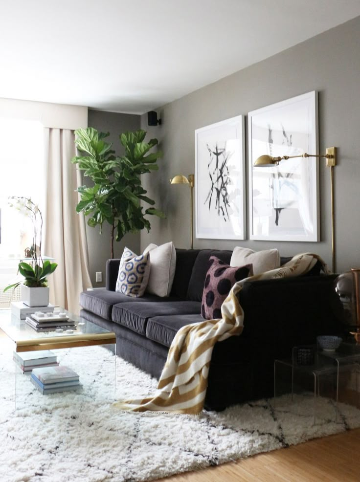 a living room filled with furniture and a large plant in the corner on top of a computer screen