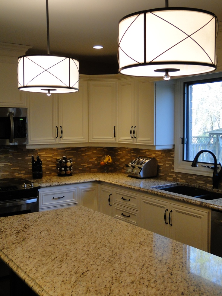 Drum pendant lights over the kitchen island. Could put this lighting