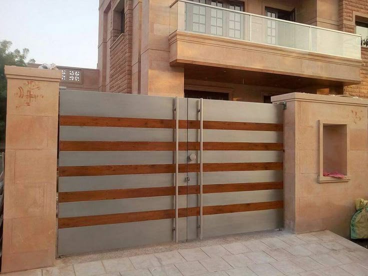 A Modern Gate In Front Of A Building With Brick Walls And Balconies On a-modern-gate-in-front-of-a-building-with-brick-walls-and-balconies-on