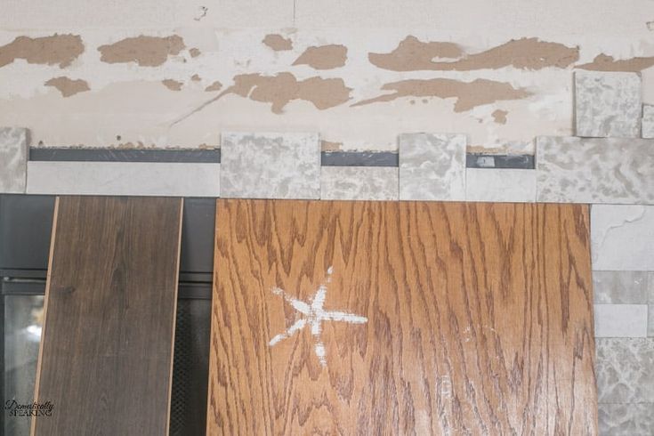 Holding up the faux stone while it dried over the fireplace opening.