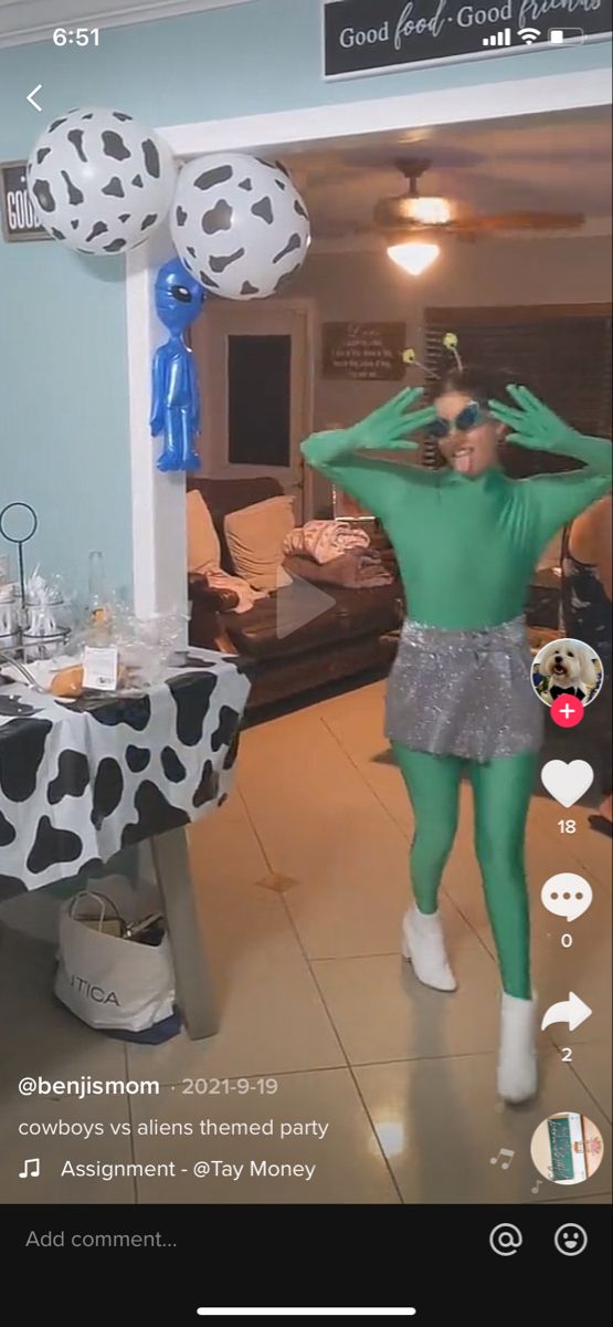 a woman in a green outfit is dancing