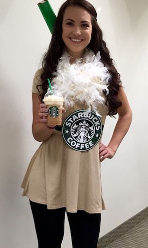 a girl in a starbucks costume holding a cup of coffee