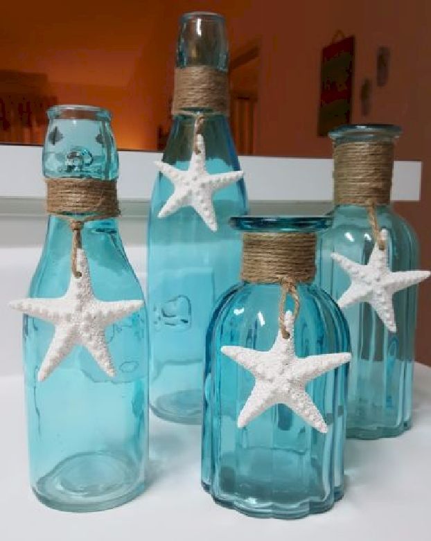 four bottles with starfish decorations in them