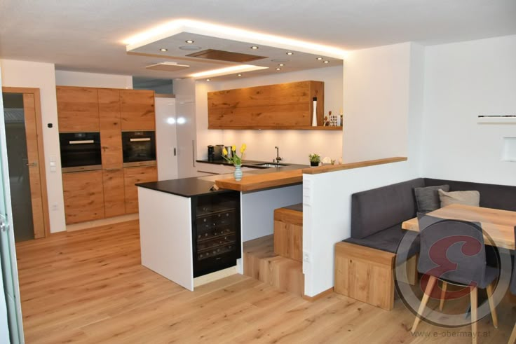 a kitchen and living room with wood floors