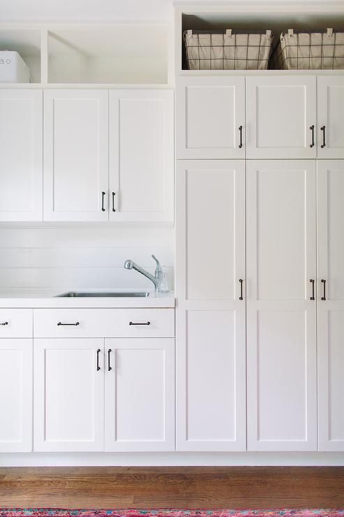 All White Laundry Room Features Shaker Cabinets Adorned With All White Laundry Room Features Shaker Cabinets Adorned With Oil Rubbed Bronze Pulls Paired Rooms In 2018 Pinterest