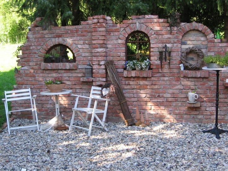 chairs and tables sitting in front of a brick wall