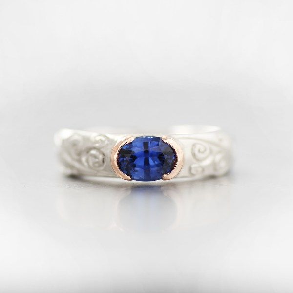 a deep blue sapphire paired with a rose and white gold hand carved band makes - One Of A Kind Wedding Rings a deep blue sapphire paired with a rose and white gold hand carved band makes - One Of A Kind Wedding Rings