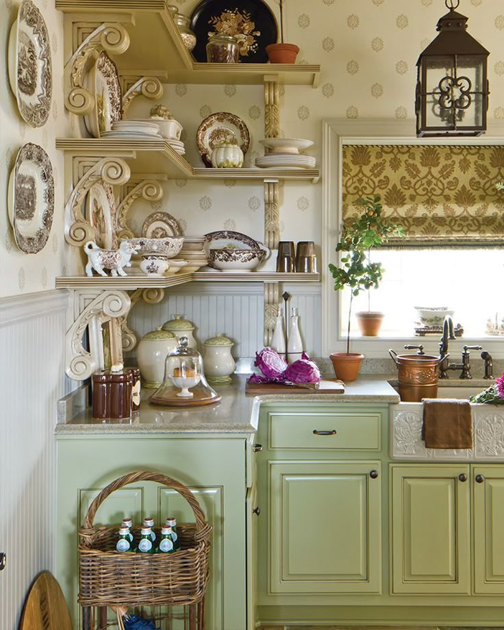 a kitchen filled with lots of green cupboards and counter top space next to a window