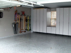 Custom Gray Cabinets Surround The Window And Gray Storewall Panels Line The Walls Creating Tons Of Storage By Garage Desi Garage Design Grey Cabinets Design