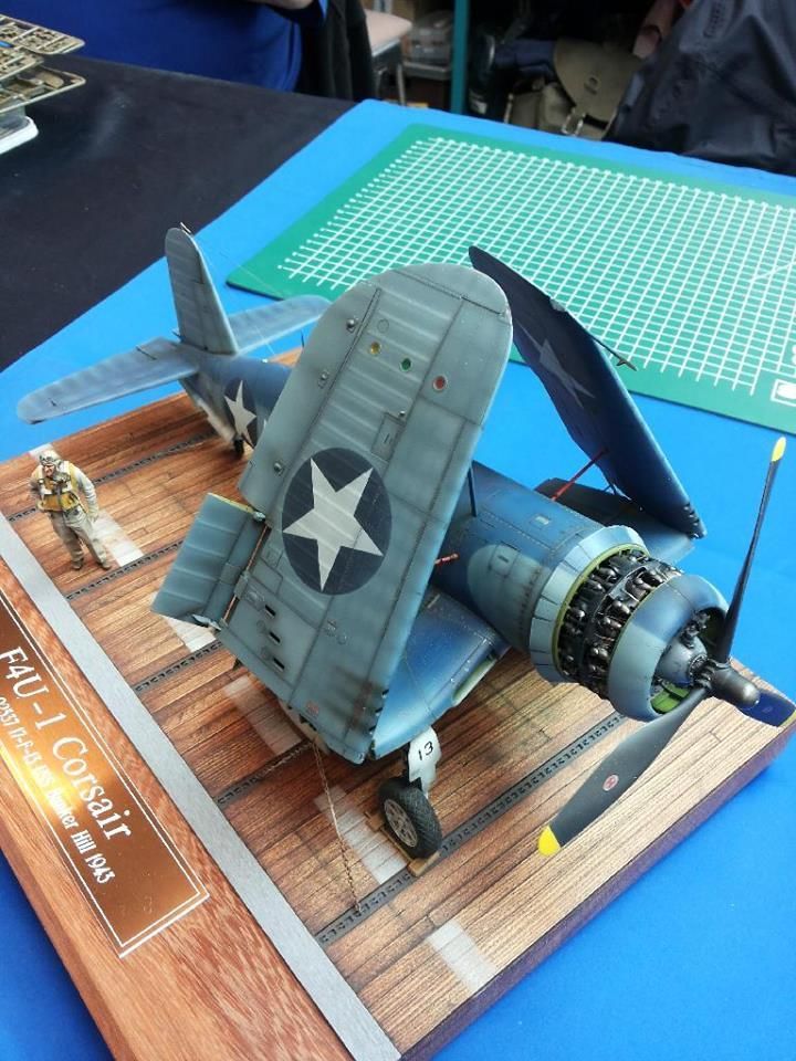 A Model Airplane Sitting On Top Of A Wooden Table Next To A Blue Table model-airplane-maker-building-and-improving-scale-models