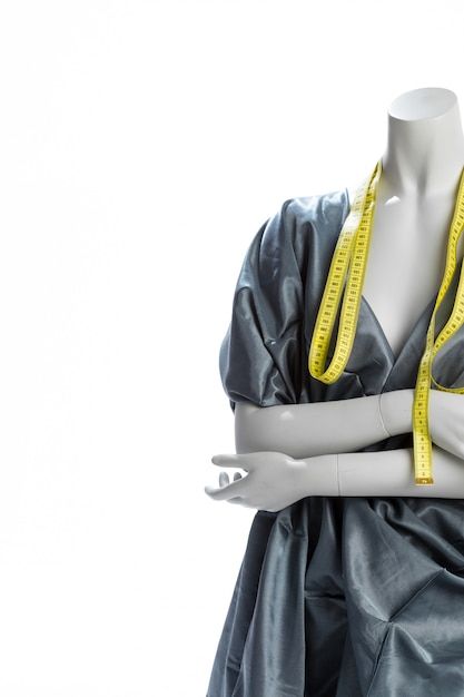 A Mannequin With A Measuring Tape Wrapped Around It s Neck And Arms a-mannequin-with-a-measuring-tape-wrapped-around-it-s-neck-and-arms
