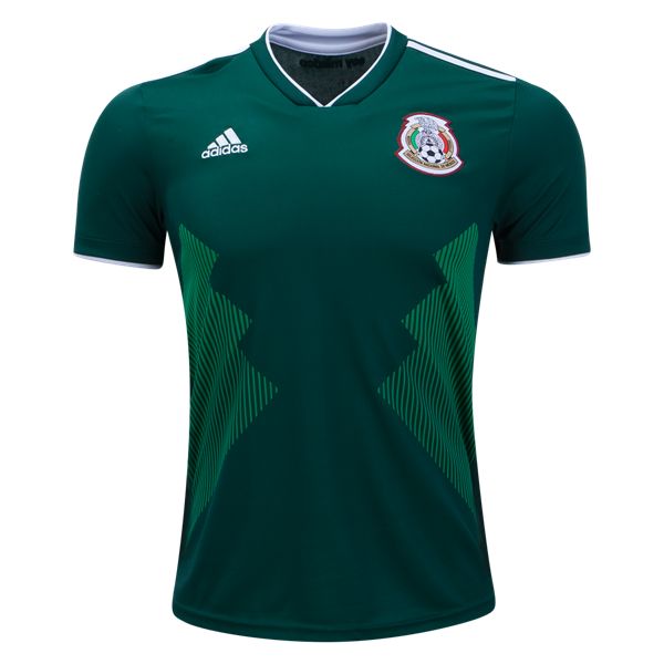 a green soccer jersey with white trims and an emblem on the chest, in