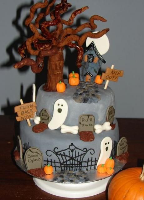 two tier gray halloween graveyard theme cake with ghosts and tree and haunted house