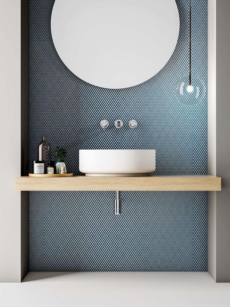 Love the tile with the circular mirror and pale wooden vanity. Clear, single globe light and cute tray of bathroom essentials. Very crisp. #homedecor