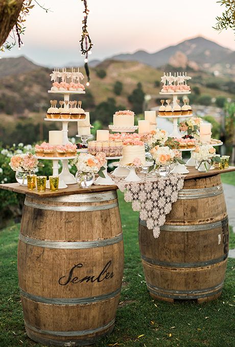 the wedding cake is on top of two wooden barrels