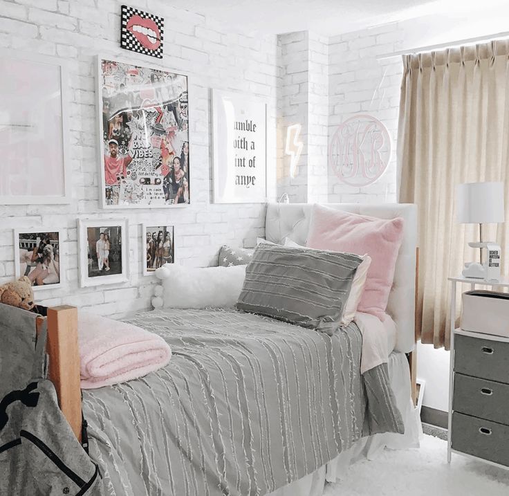 a bedroom with white brick walls and pictures on the wall, including a ...