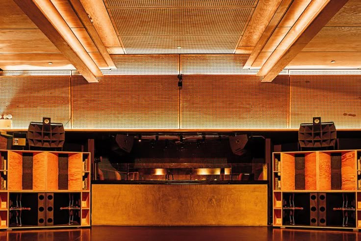 an empty room with wooden shelves and lights