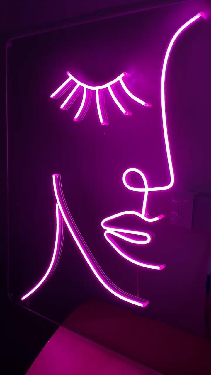 A Neon Sign With A Woman s Face On It A Neon Sign With A Woman s Face On It