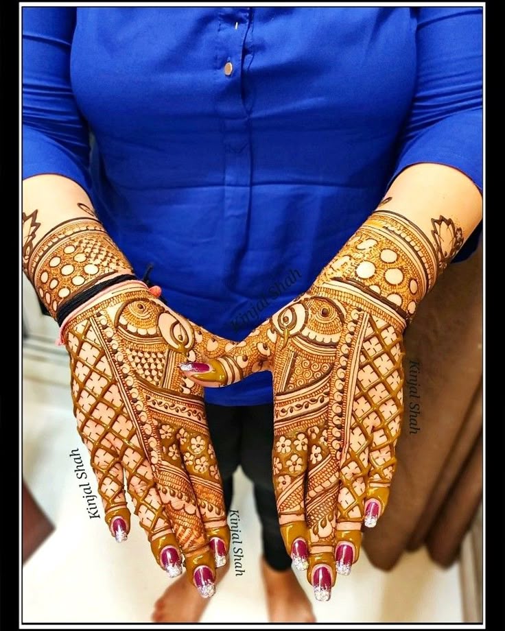 This may contain: a woman's hands decorated with hennap