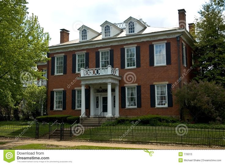 A Large Red Brick House With Black Shutters And White Trim On The Front A Large Red Brick House With Black Shutters And White Trim On The Front