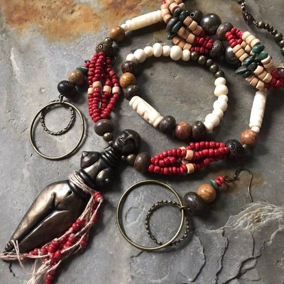 Spiritual earrings with fertility goddess charms and combined with water bleu clay beads