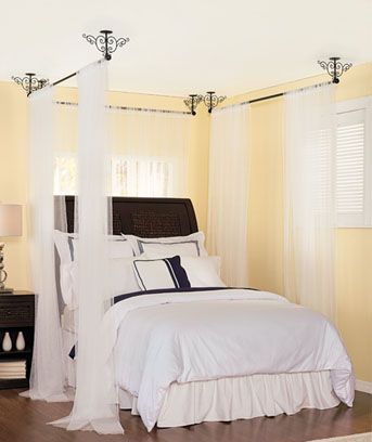 You can mount a single hoop or curtain rod to the ceiling in the middle of your bed and drape fabric from it over the ends of your bed. You can mount a single hoop or curtain rod to the ceiling in the middle of your bed and drape fabric from it over the ends of your bed.