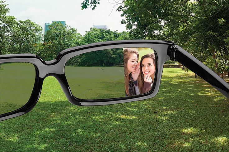 Glasses With Mirrors To See Behind You a pair of sunglasses with two women's faces reflected in them