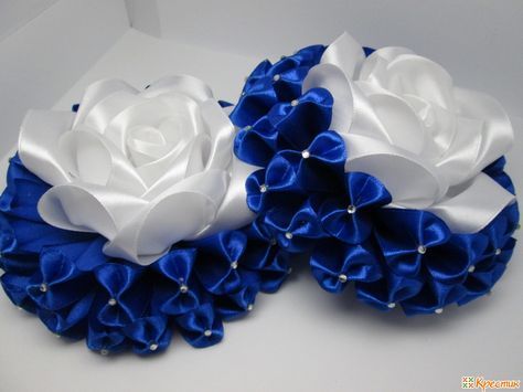 two blue and white flowers with pearls on them