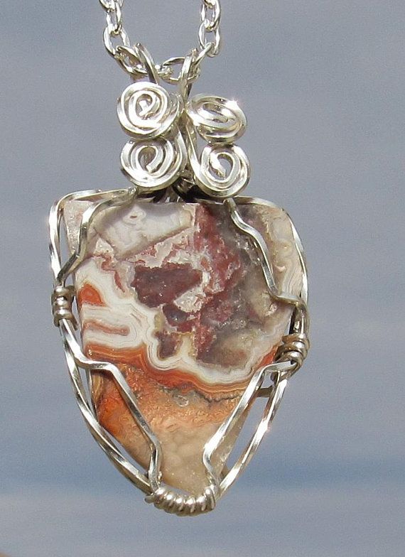Crazy lace agate wire wrapped pendant in sterling silver plated wire