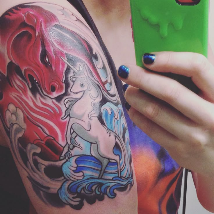 the last unicorn vs the red bull. tattoo by chris bettley