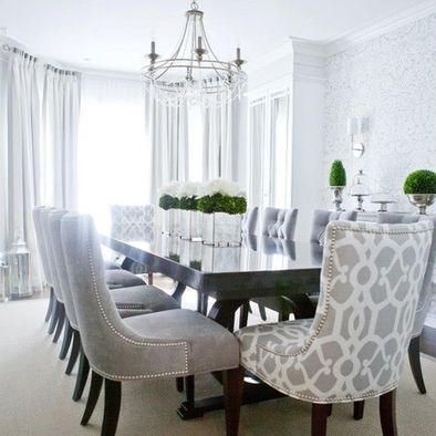 a dining room table with chairs and a chandelier