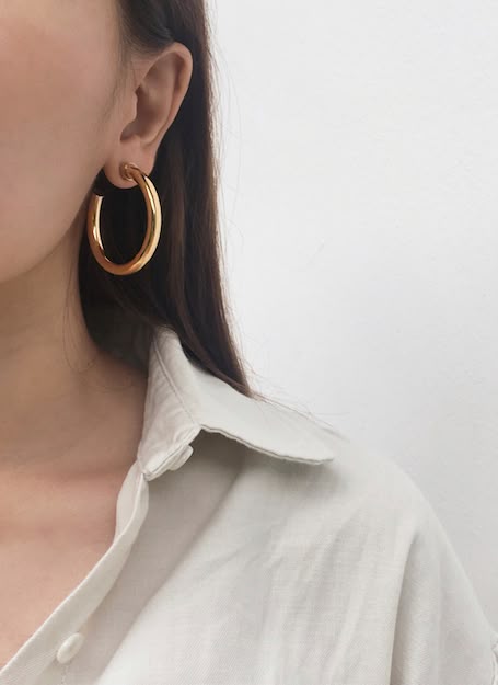 Wearing the Usu Hoops in Gold. A classic, c-shape open thick hollow hoop by The … Wearing the Usu Hoops in Gold. A classic, c-shape open thick hollow hoop by The …