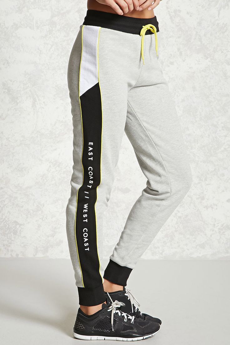 A Pair Of Knit Athletic Joggers Featuring East Coast West Coast Graphics On The Sides Colorblock Panels Contrast Pip Esofman Altlari Spor Giyim Erkek Giyim