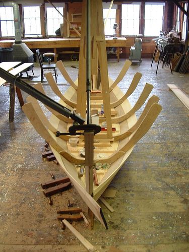 a wooden boat being built in a workshop