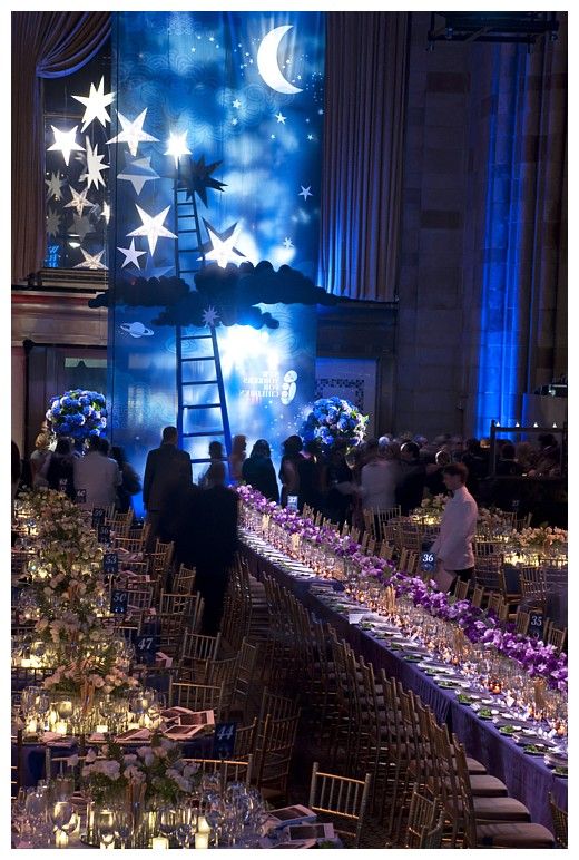 A Long Table Is Set Up With Candles And Place Settings a-long-table-is-set-up-with-candles-and-place-settings