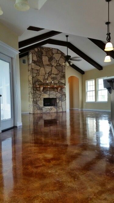 Rustic Living Room With Abundant Natural Light Flagstone Wood Rustic Living Room With Abundant Natural Light Flagstone Wood Burning Fireplace Stained Concrete Floor And Exposed Cedar Beams Fr