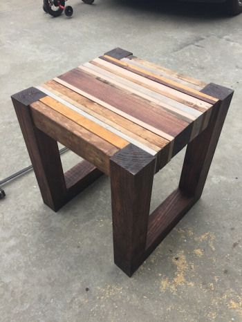 a small wooden table sitting on top of cement