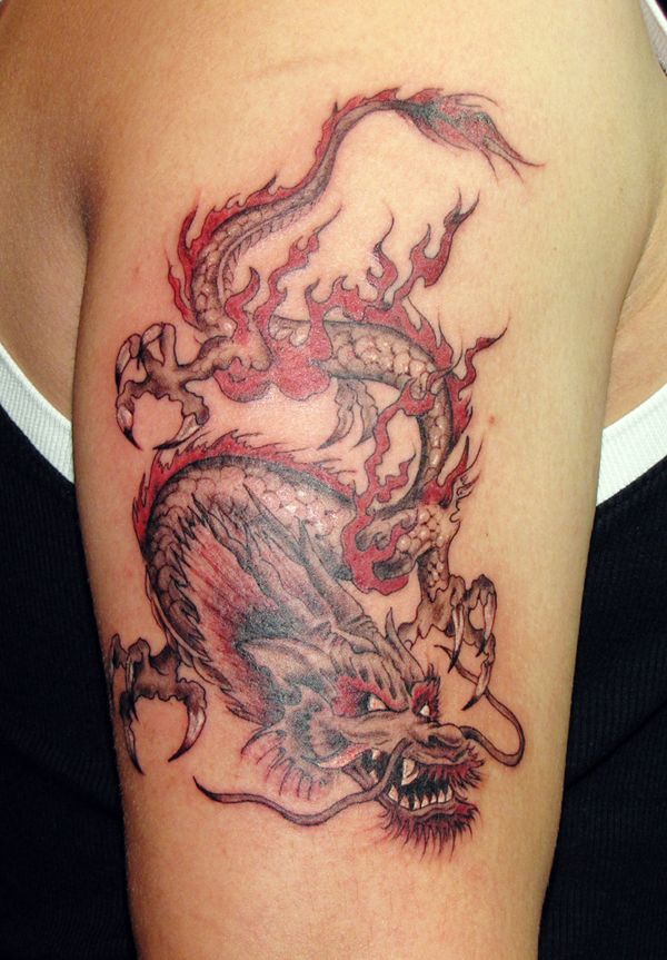 a woman with a dragon tattoo on her arm