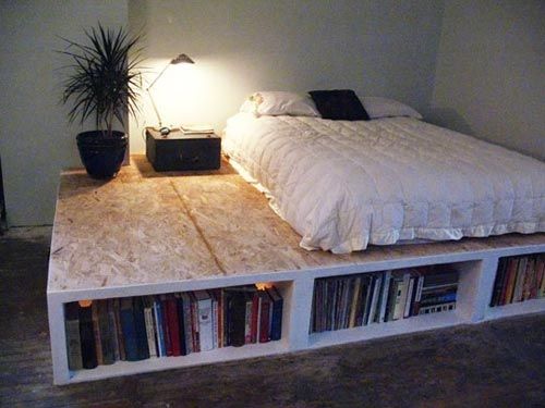 a bed made out of bookshelves in a room