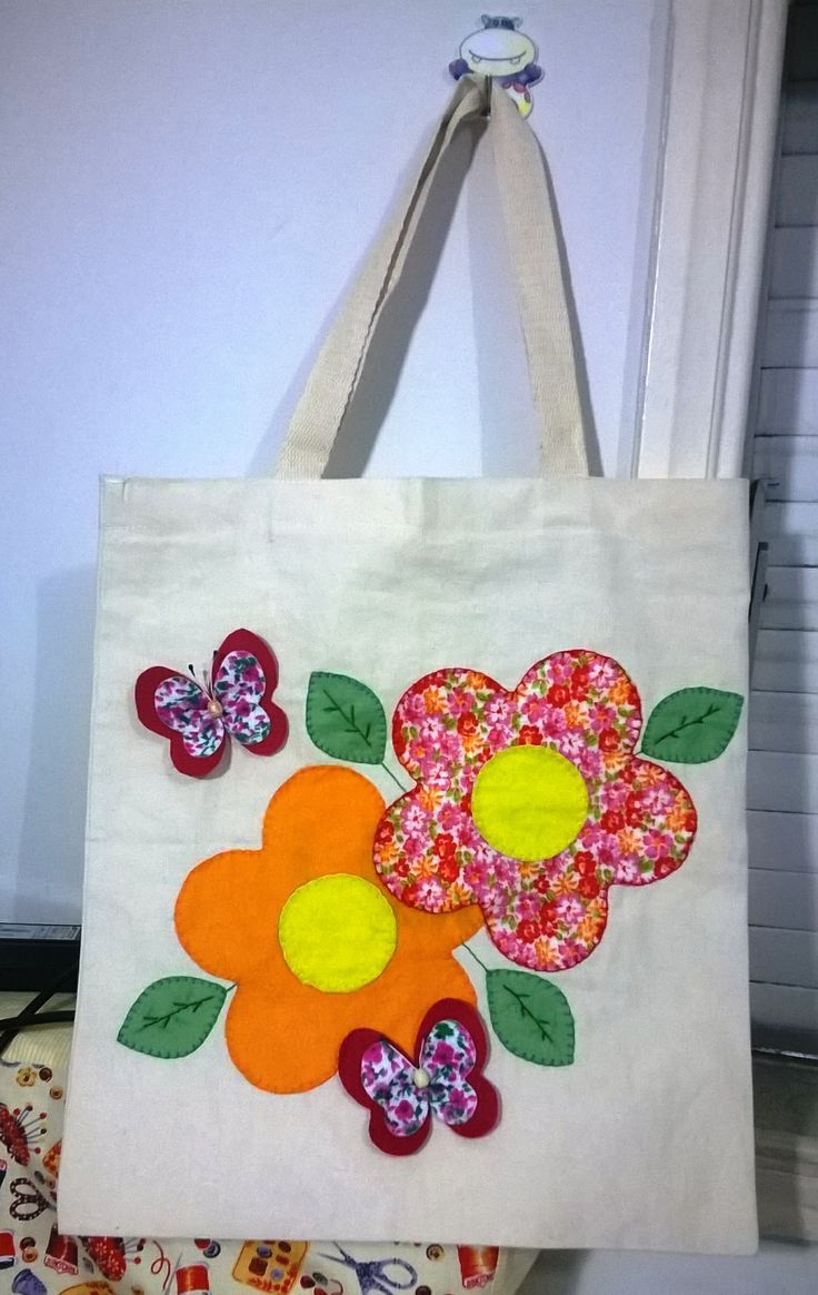 a white bag with flowers and leaves on it