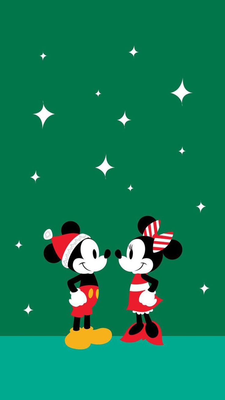 two mickey and minnie mouses standing in front of the stars on a green background