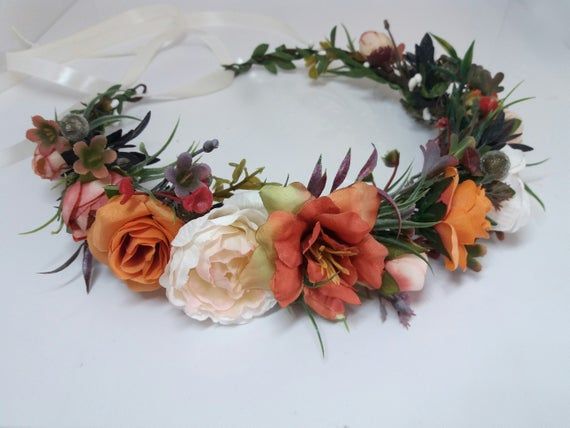 an orange and white flower crown on a table