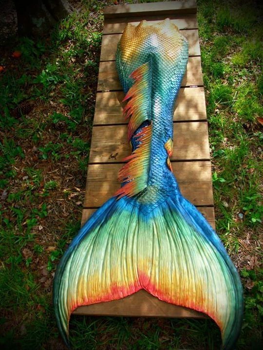 Rainbow silicone mermaid tail by Merbella Studios. Swimmable mermaid