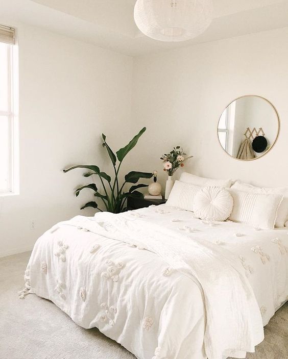 minimalist bedroom; all white with plants and gold accents