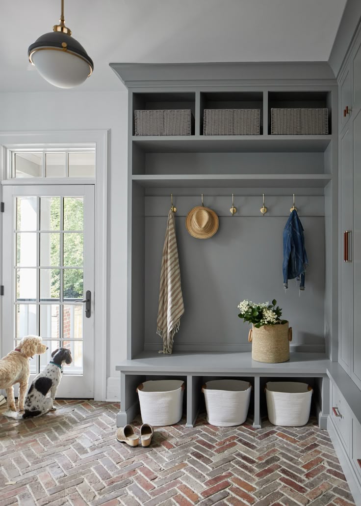 Mudroom with Built ins and herringbone brick floor