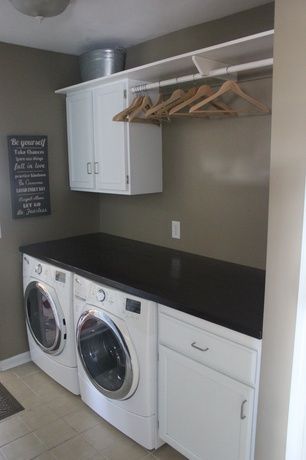 Contemporary Laundry Room with Built-in bookshelf, limestone tile floors, flush ...