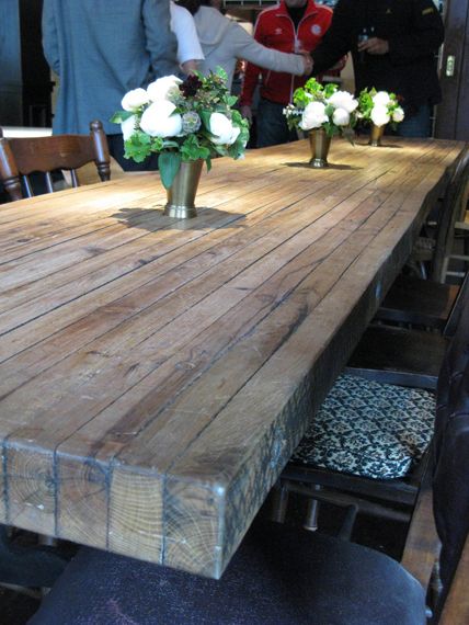 a wooden table with vases on top of it